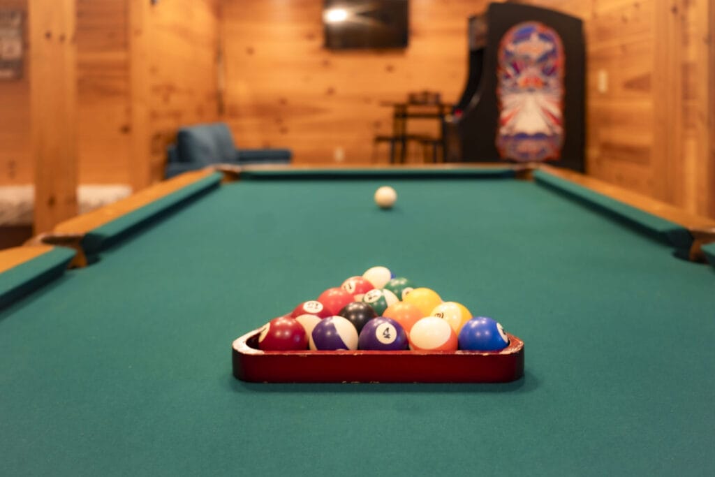Pool table with organized pool balls in the game room of the Lincoln Logs Cabin